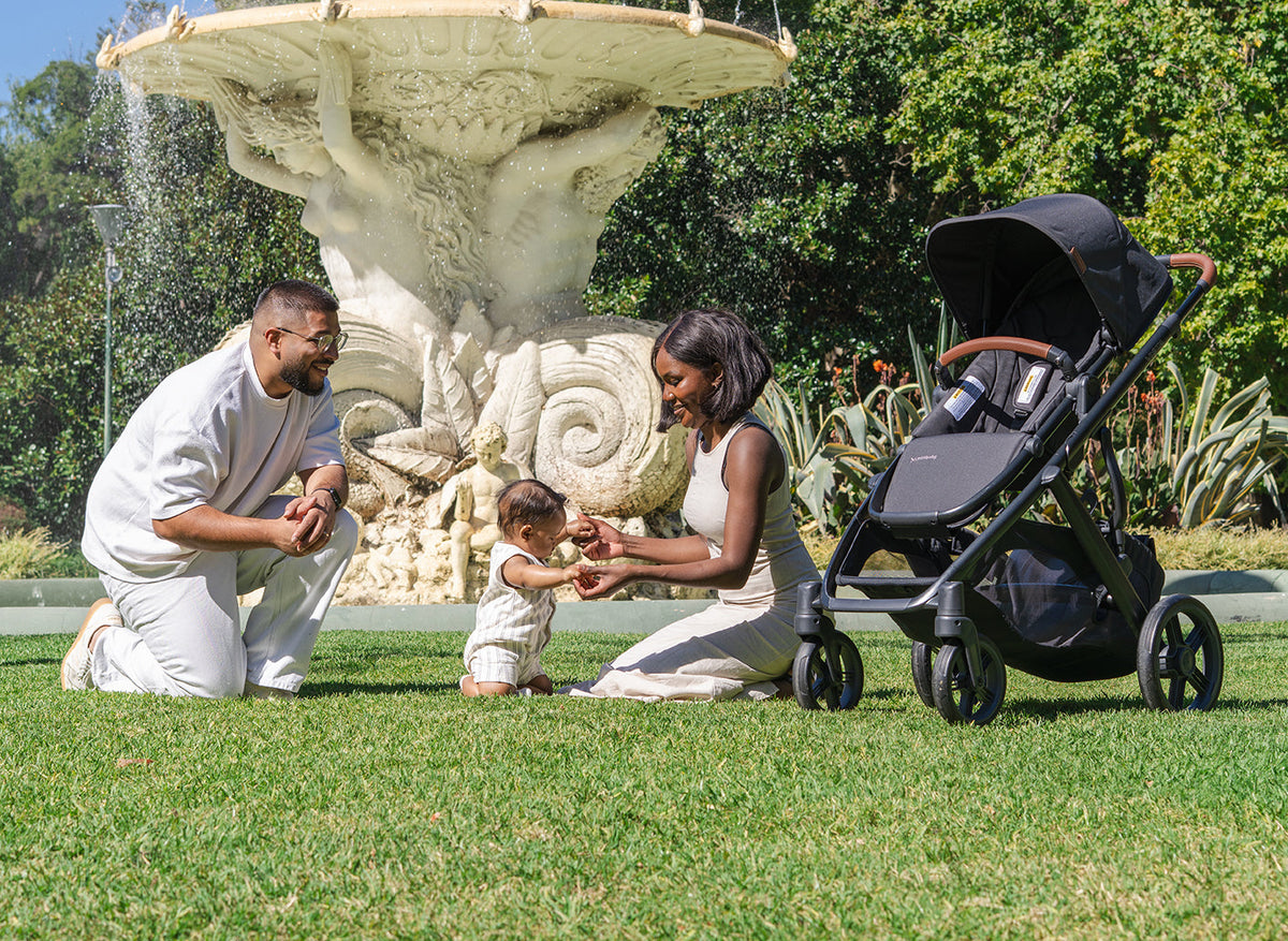 A family in a park with an UPPAbaby Cruz V3