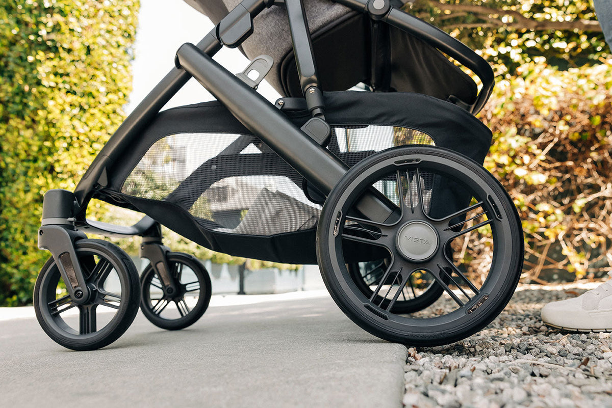The wheels and lower frame of an UPPAbaby Vista V3