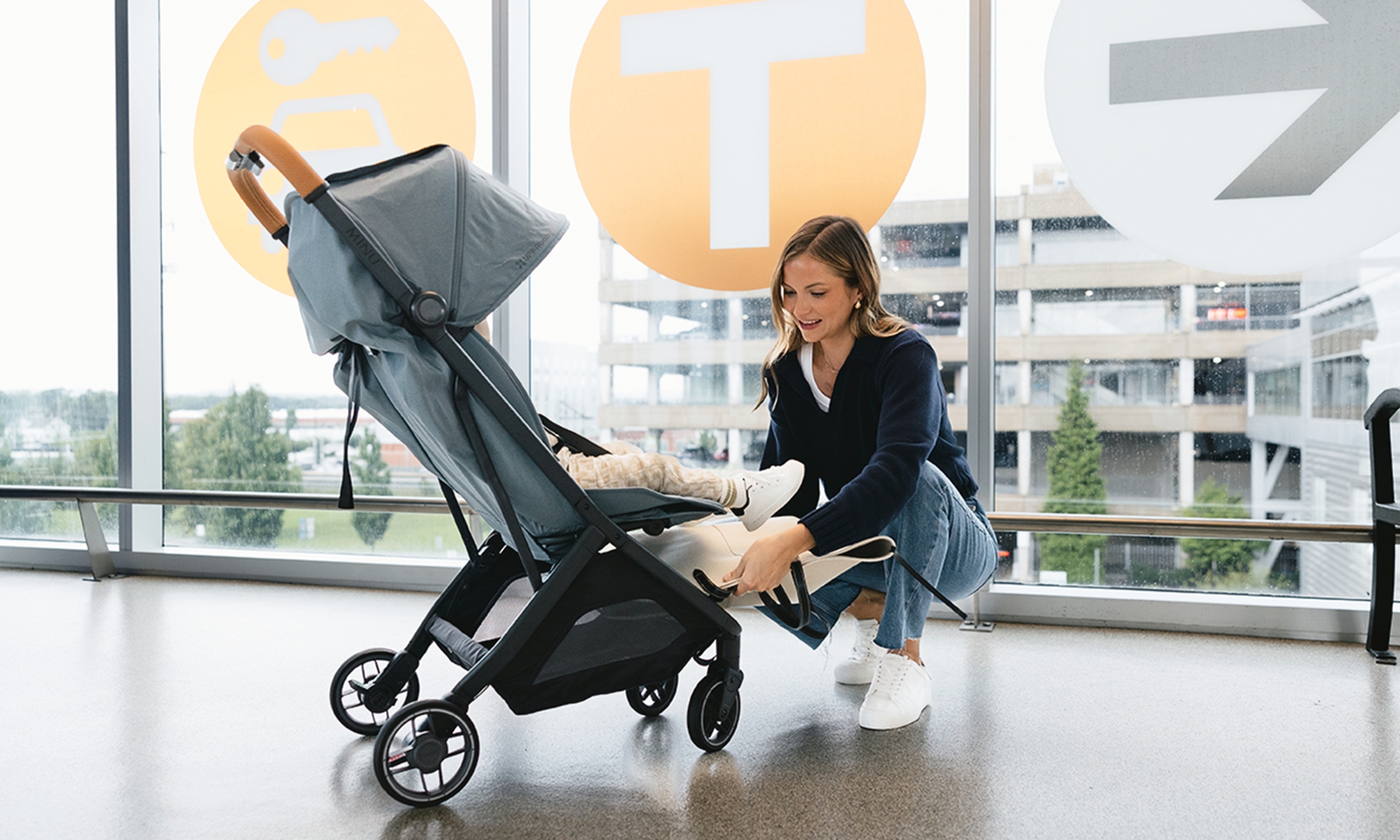 UPPAbaby MINU V3 compact travel pram folded and in use outdoors