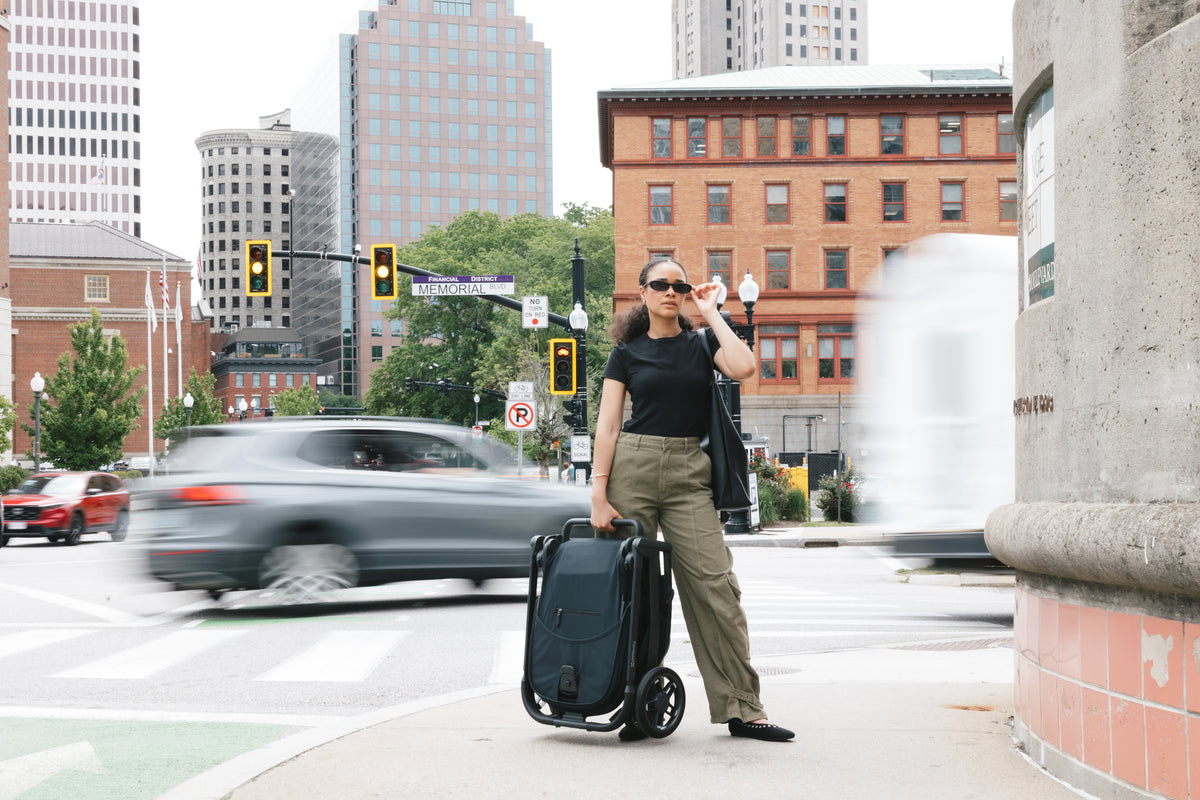 Carrying a folded UPPAbaby Kona across a city street