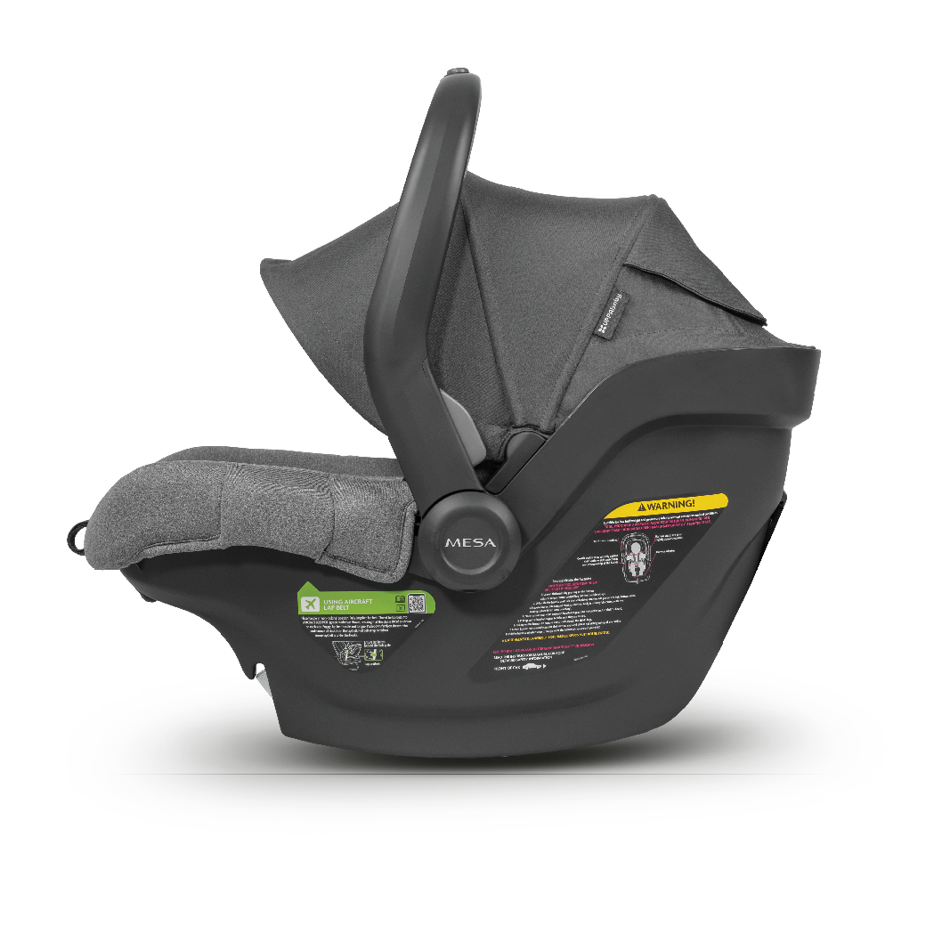 A dark gray and black MESA infant car seat with a matching fabric canopy, shown from a side profile view on a white background.